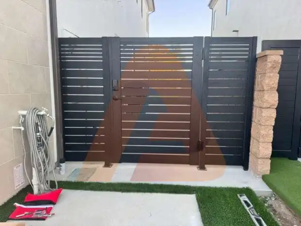 ALU 20 black slat driveway gate installed by Aluglobus Aluminum Systems