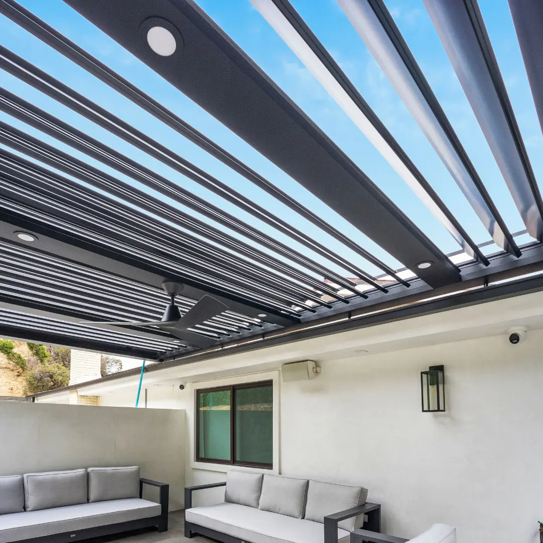 Installed ceiling fan and recessed lighting integrated into an aluminum louver patio