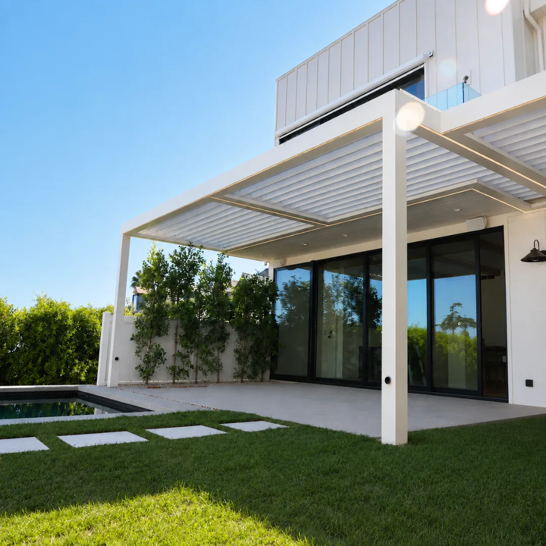 White motorized aluminum louver patio cover beside a modern home and swimming pool