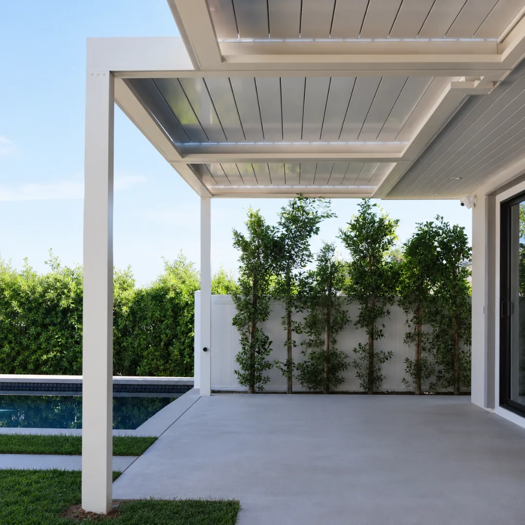 White automatic louver patio cover closed to create full shade beside a pool