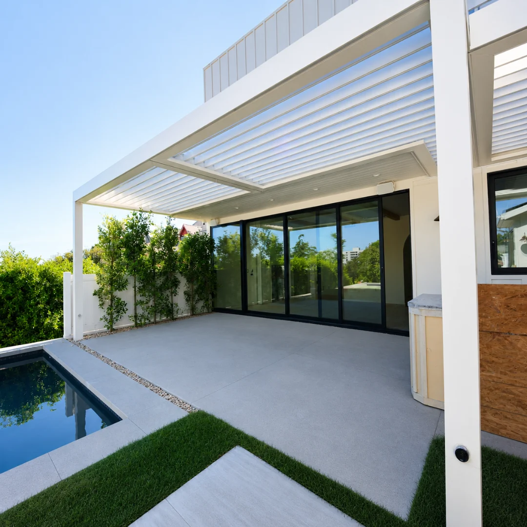 White automatic louver pergola with open roof beside a swimming pool