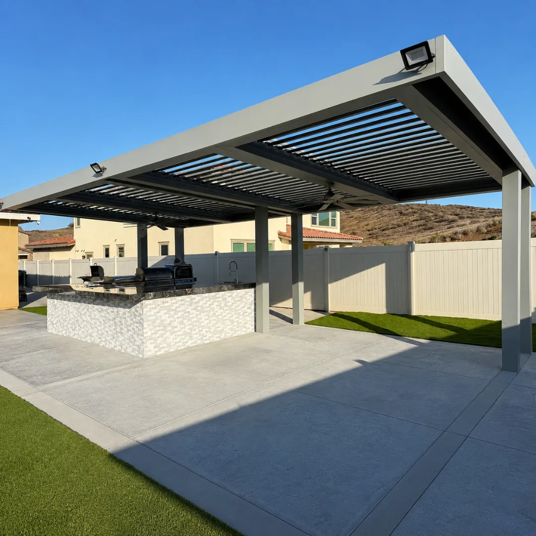 Gray motorized louver pergola with open roof above an outdoor kitchen