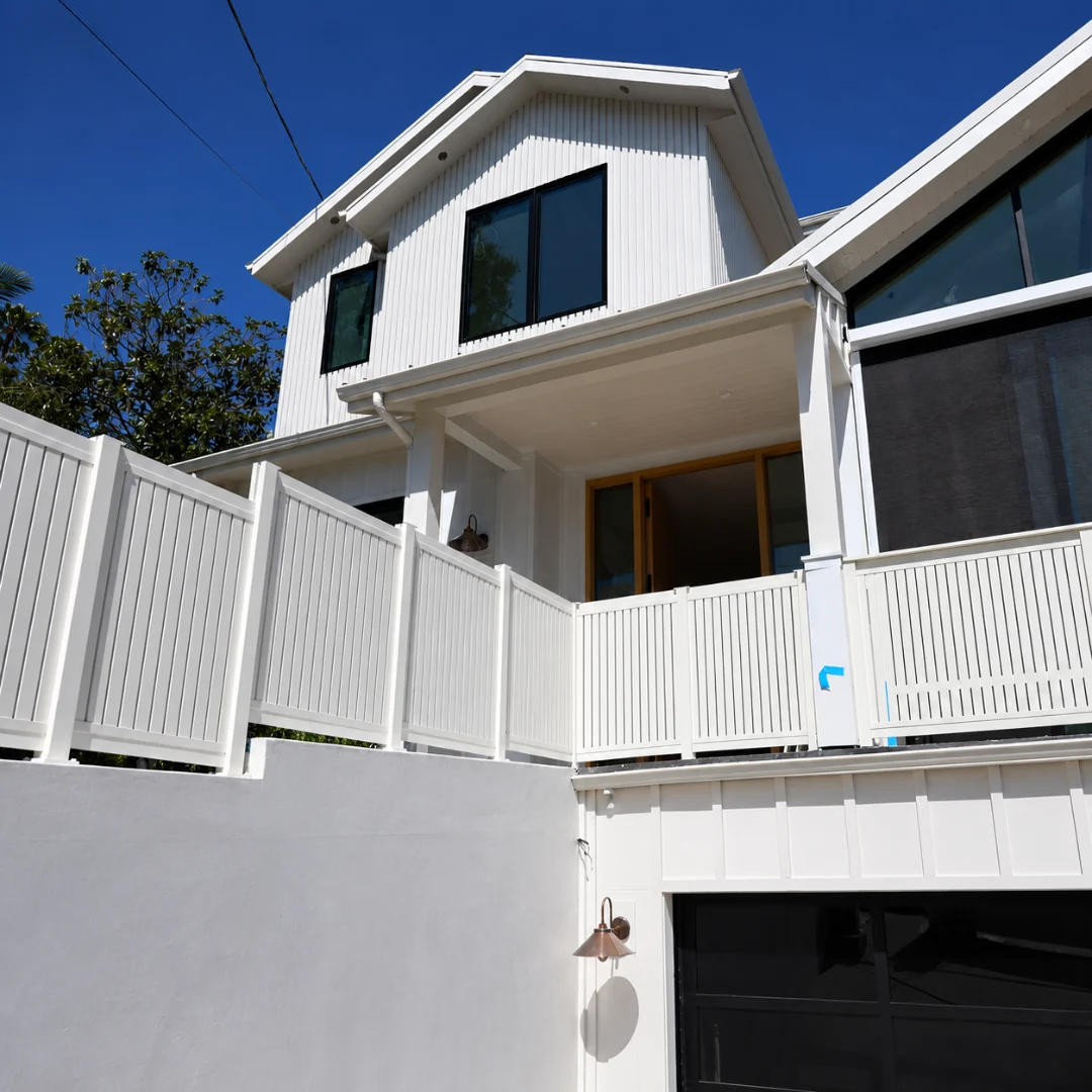 White modern home exterior with aluminum patio and railing systems