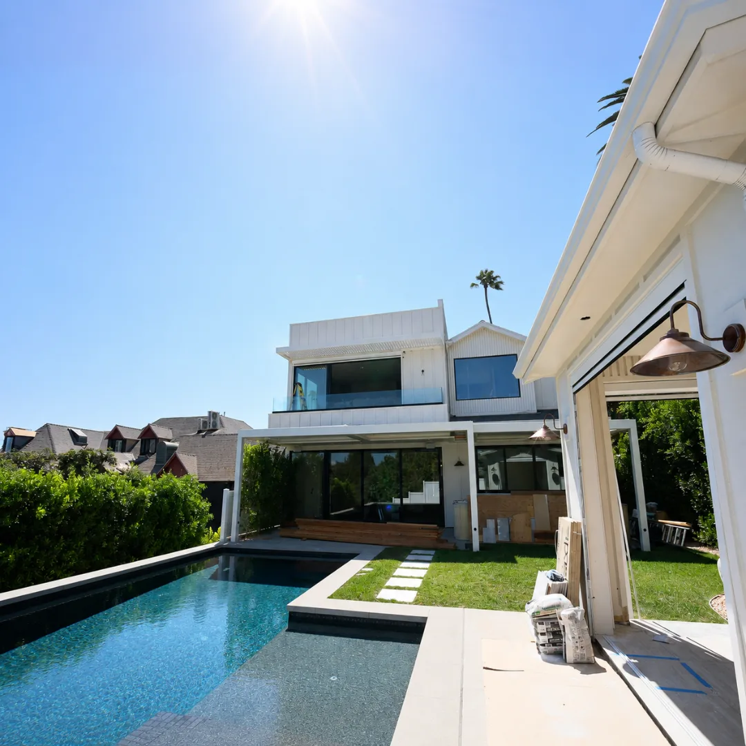 Modern backyard with pool and white automatic louver patio cover
