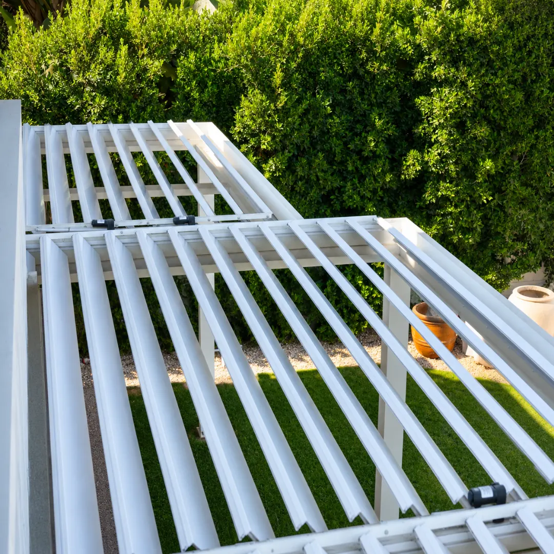 Top view of white motorized louver blades and operating linkage