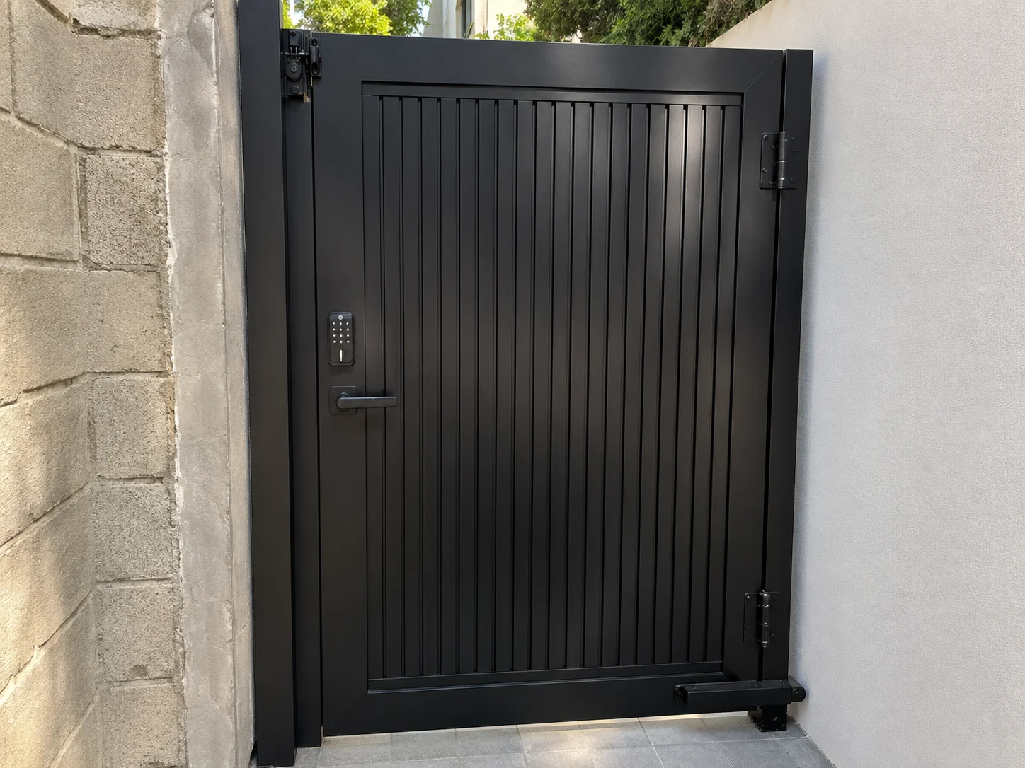 Real aluminum pedestrian gate installation showing Heavy-Duty hinges, lock preparation and structural post