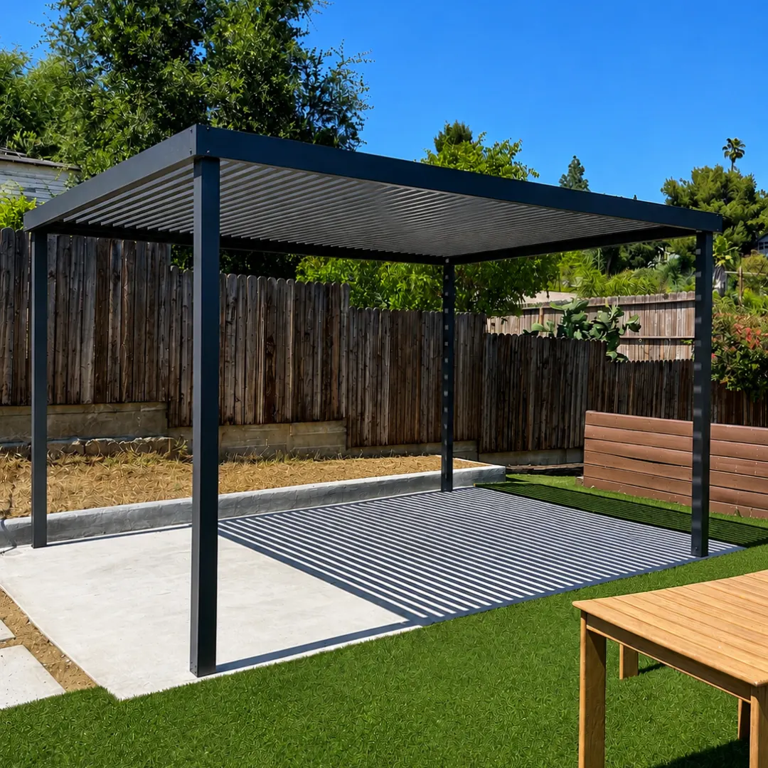 Freestanding black aluminum slat patio cover over a backyard concrete patio with striped shade