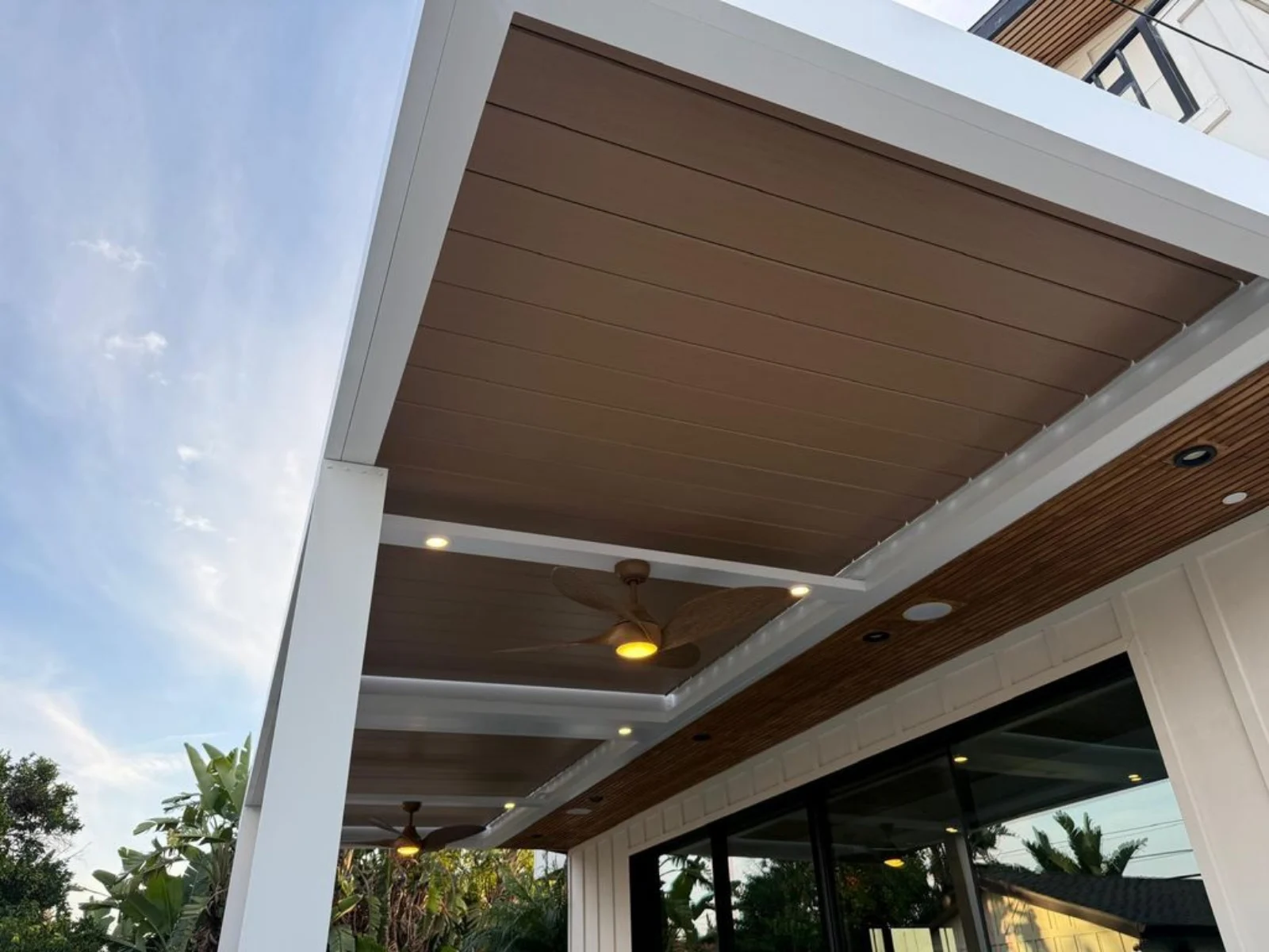 Automatic louver pergola installation showing aluminum posts beams and roof system