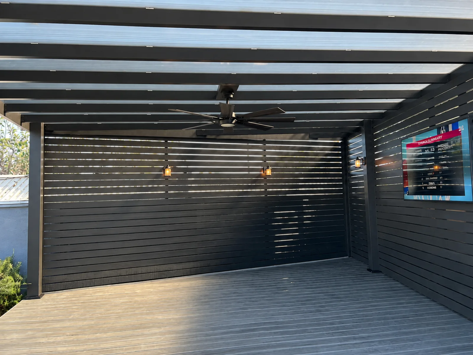 Finished aluminum beam pergola integrated with an outdoor living area