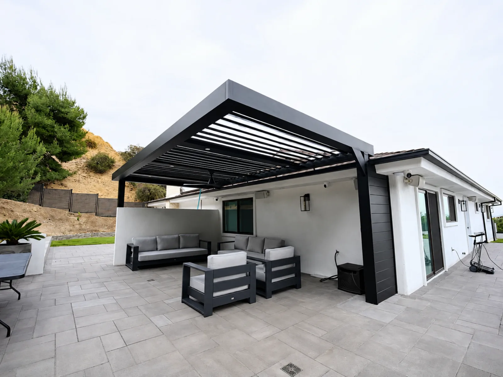 Motorized aluminum louver patio cover installed over a residential outdoor space
