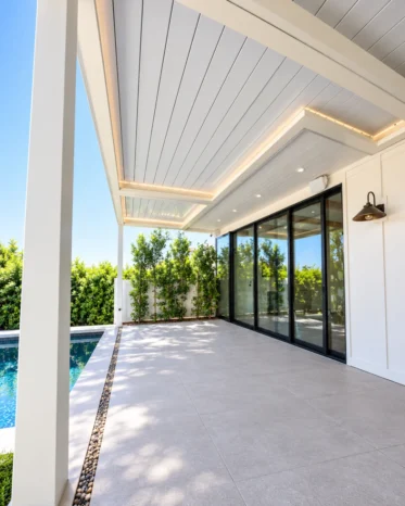Aluglobus motorized louver roof with internal LED recessed downlights and perimeter strip channels.