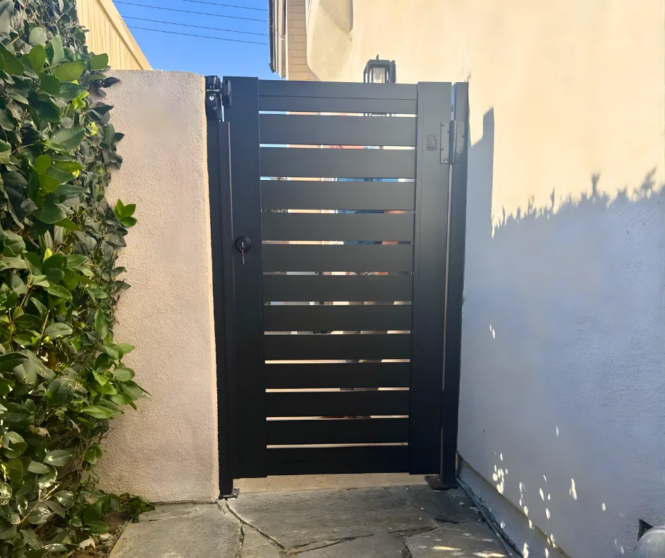 Spaced horizontal infill slats in a black aluminum gate