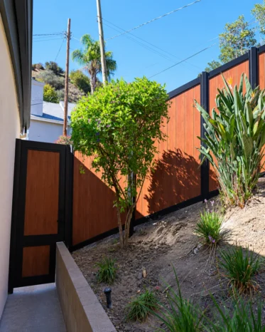 Close-up of smart Bluetooth digital lock handle mounted on Alu60 woodgrain aluminum pedestrian gate.
