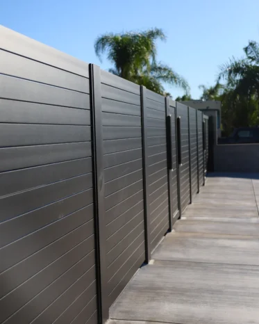 Modern Alu40 black aluminum horizontal slat fence and matching pedestrian gate installed in Miami Florida.