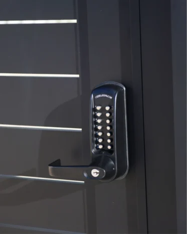 Motorized aluminum sliding driveway gate gliding on heavy-duty ground track in Miami FL.