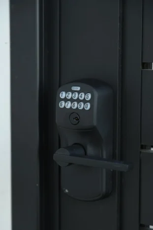Heavy-duty automated black aluminum sliding driveway gate using the Alu40 slat system.