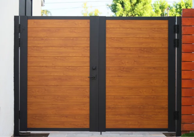 Modern tongue and groove woodgrain aluminum double gate with zero gap design.
