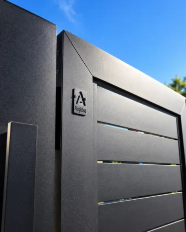 Architectural matte black horizontal slat privacy fencing along residential property boundary in Miami.