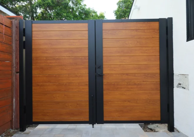 Weatherproof woodlook aluminum privacy gate resisting rot and warping installed in Westwood.