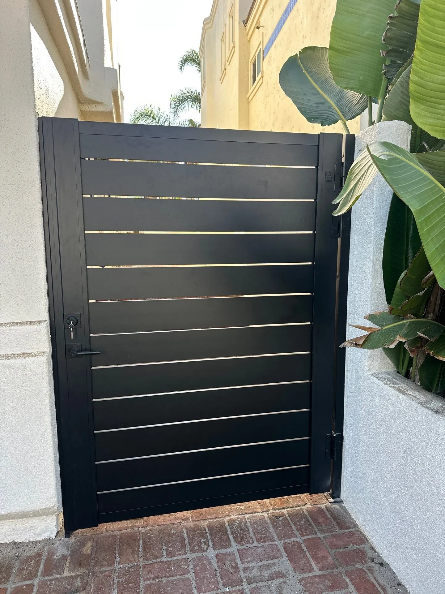 Black-finished framed gate with horizontal aluminum slats