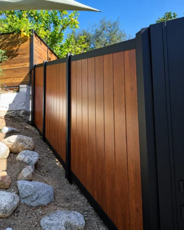 Keyless entry electronic lock system with door bell icon installed on matte black aluminum gate trim.