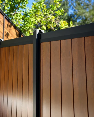 Modern smart access control handle with card reader and digital interface on black aluminum gate profile.