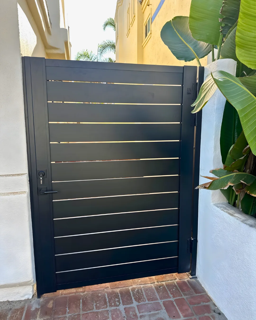 Completed black aluminum gate with horizontal infill slats