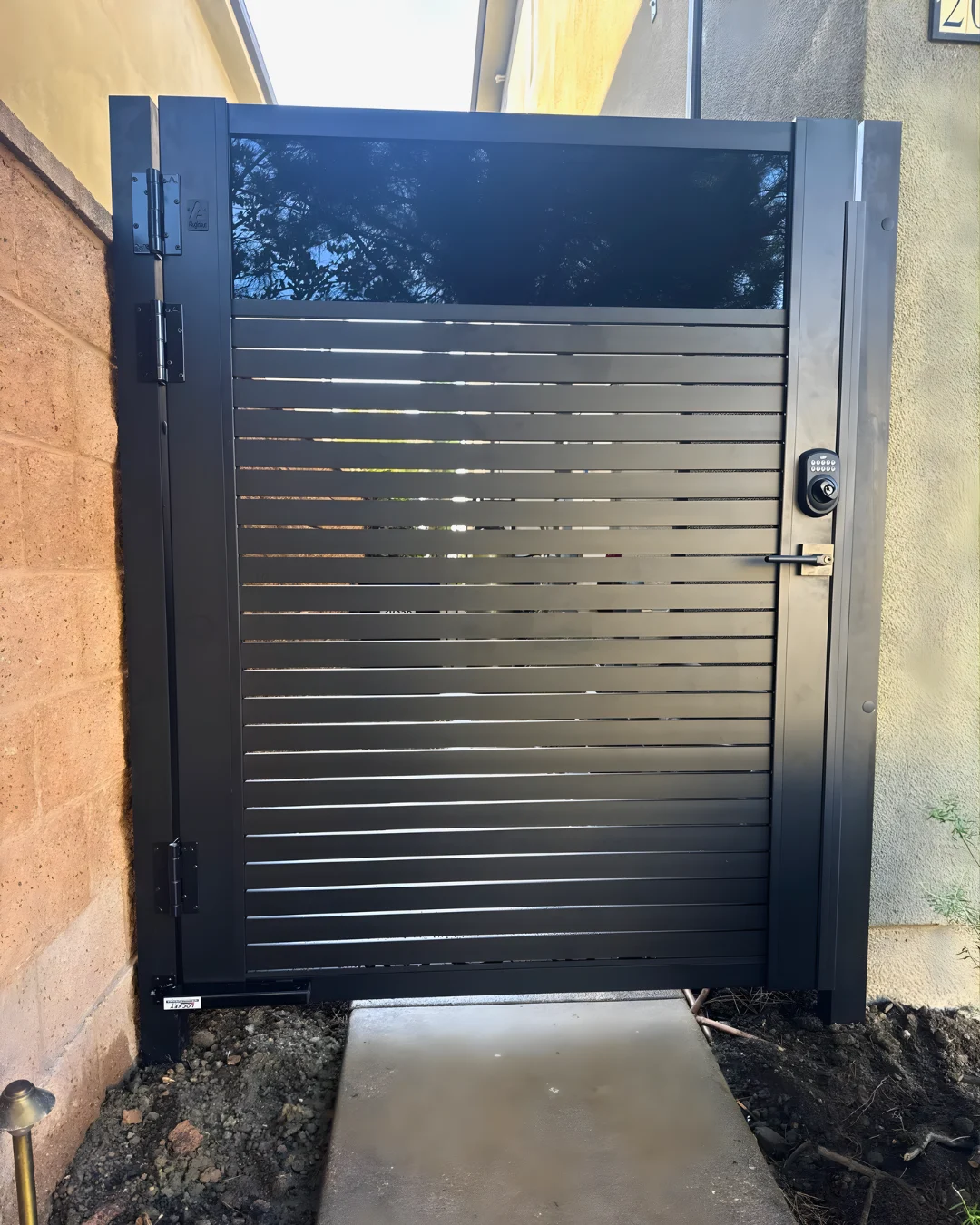 Custom gate combining narrow horizontal slats and a solid upper panel