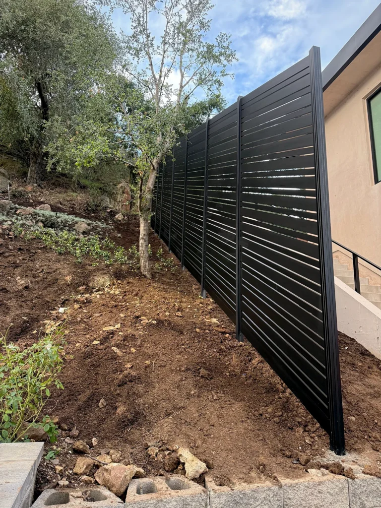 Black ALU20 fence corner on a hillside