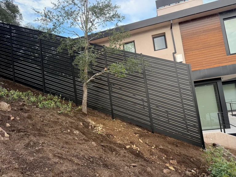Black ALU20 fence along a hillside yard