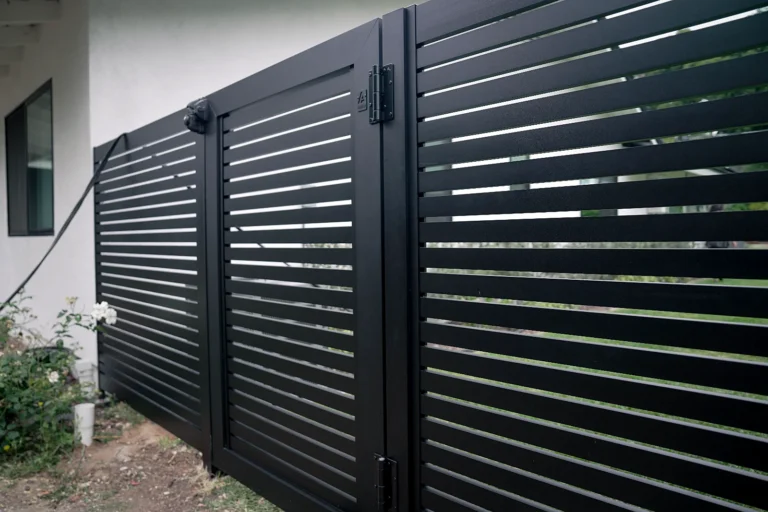 Black ALU20 fence and gate beside a modern house