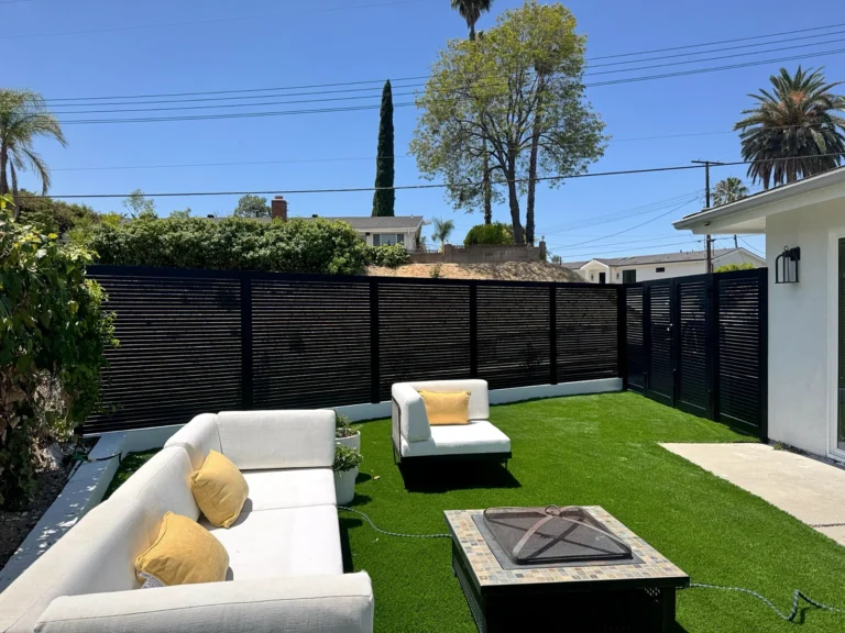 Black ALU20 privacy fence around a patio with a fire pit