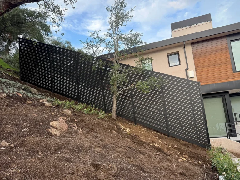 Black ALU20 fence stepping up a sloped yard