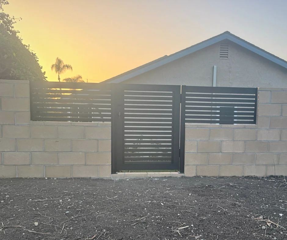 ALU20 black gate set into a block wall