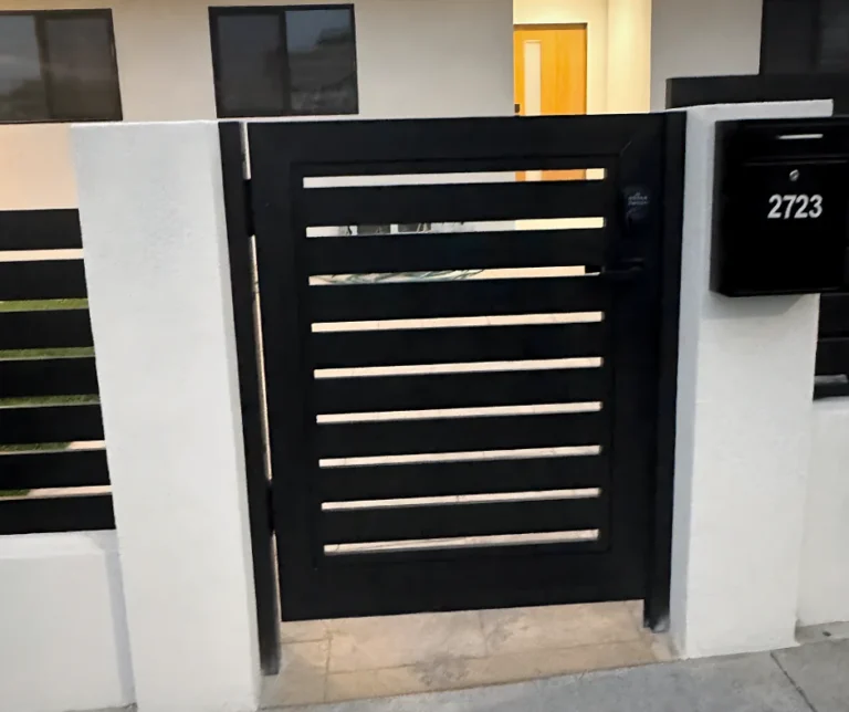 ALU20 black slat gate in a white entry wall