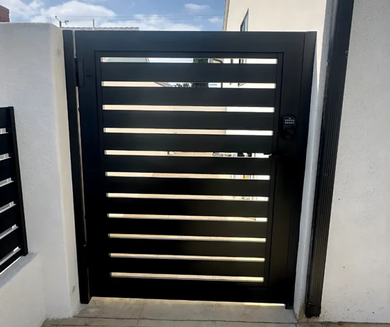 ALU20 black slat gate between white pillars