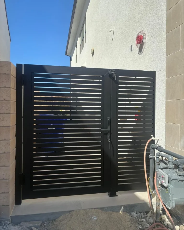 Black ALU20 gate beside a house