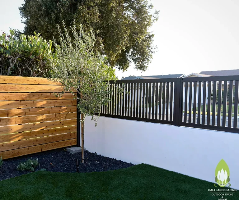 Black ALU20 vertical slat fence on top of a white wall