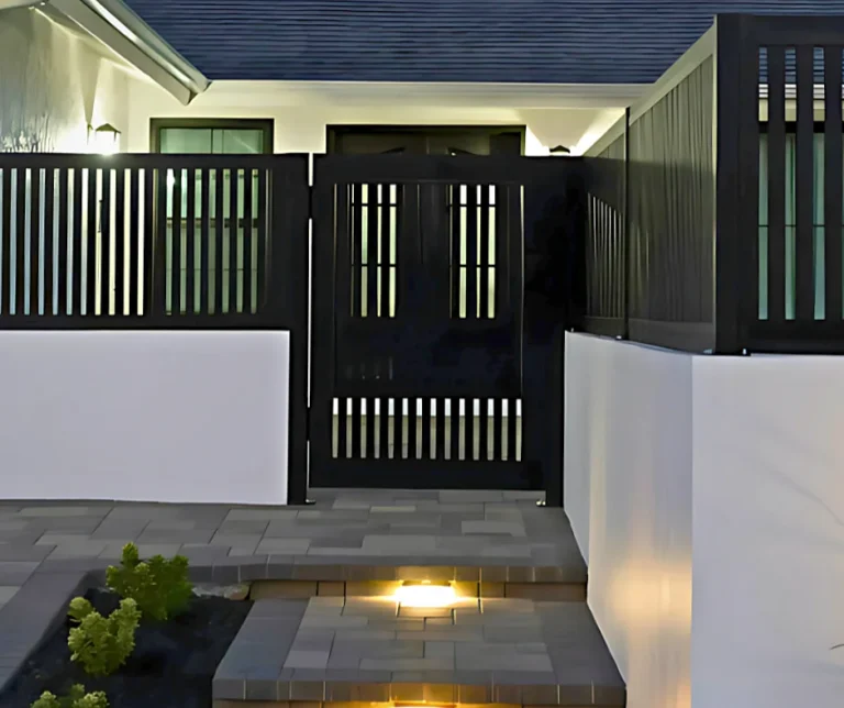 ALU20 vertical slat black gate at a lit front entry