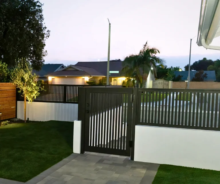 ALU20 vertical slat black gate and fence over a lawn