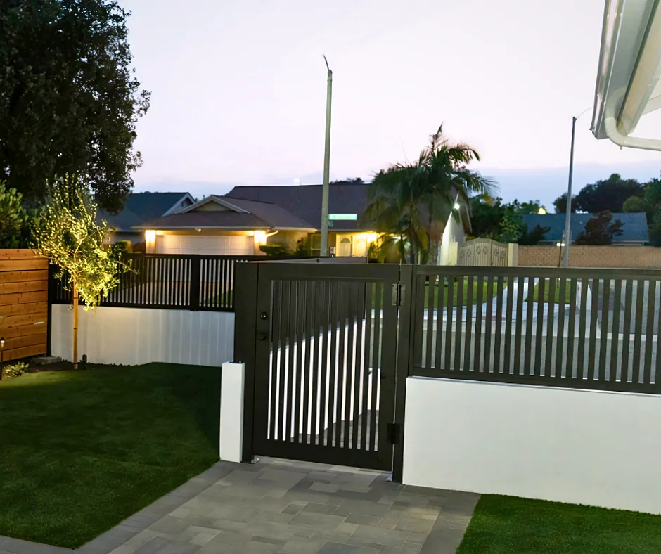 ALU20 vertical slat black gate and fence over a lawn