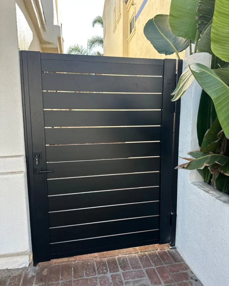 ALU 40 black slat gate over brick pavers at a courtyard entry