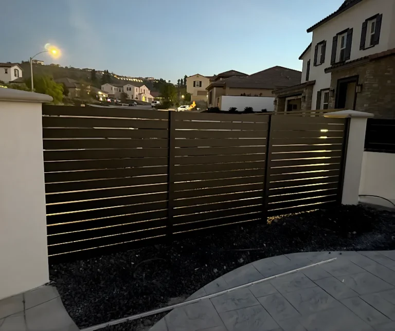 Black ALU40 fence beside a block wall at a patio