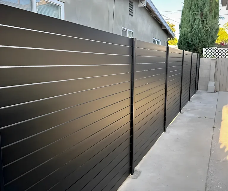 Black ALU40 fence along a concrete walk