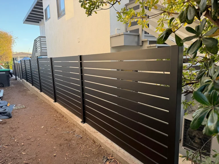 Black ALU40 fence along a side yard before landscaping