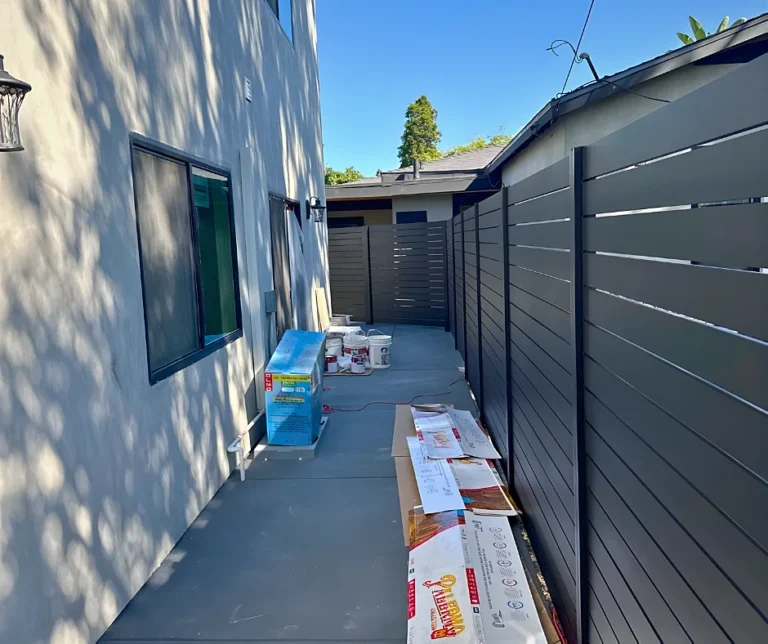 Black ALU40 fence beside a house side yard