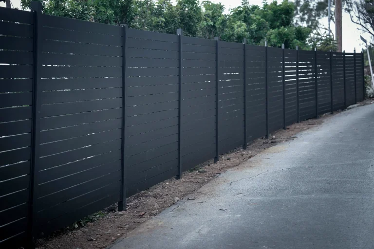 Black ALU40 fence along a narrow side path