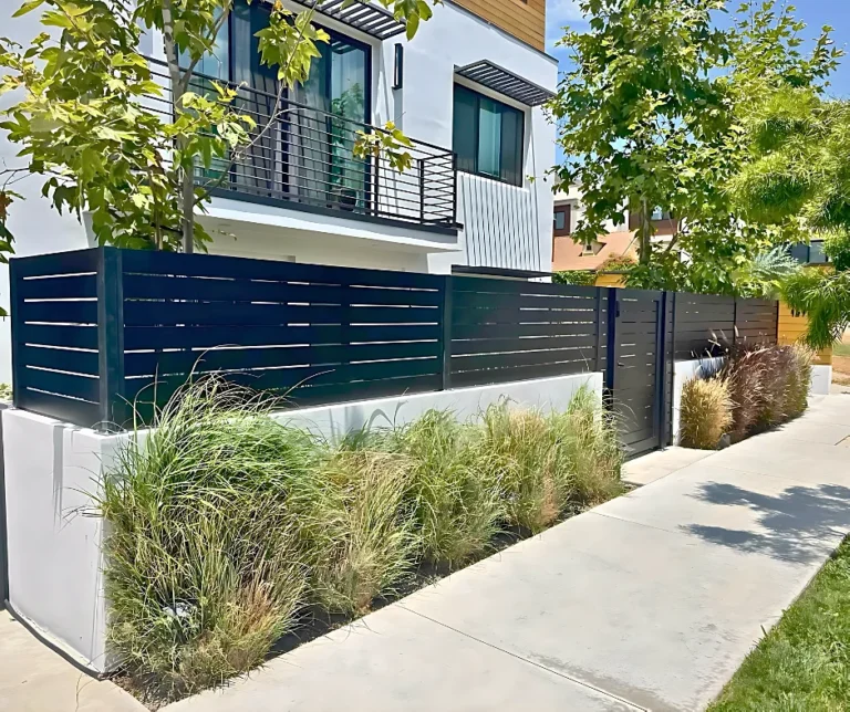 Black ALU40 fence on a raised planter at the street