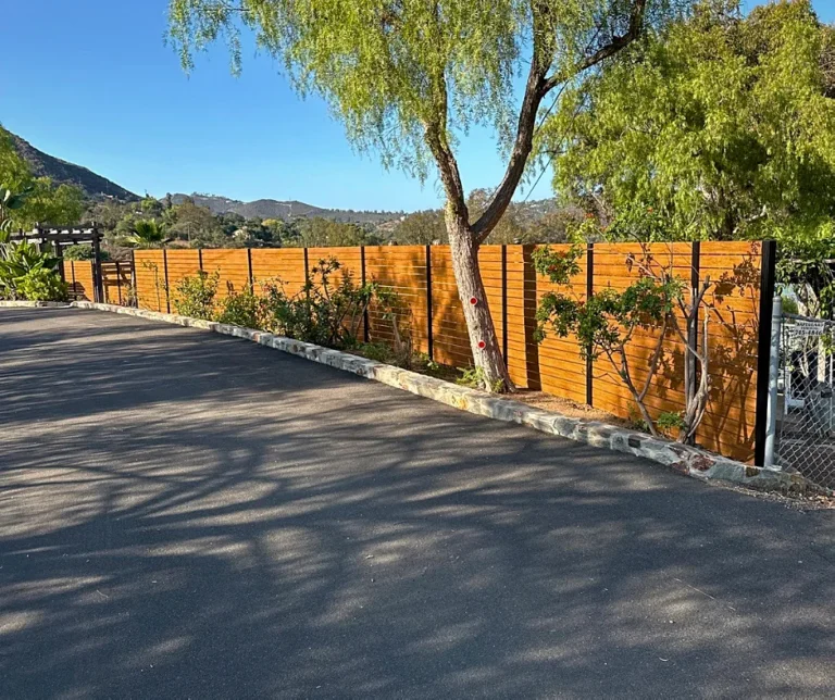 Wood grain ALU40 fence along a driveway