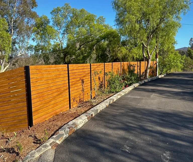 Wood grain ALU40 fence following a curved driveway